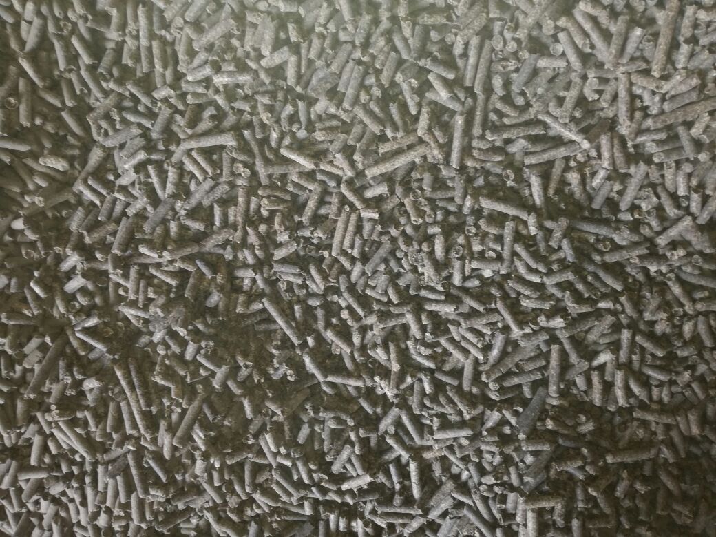 Animal feed pellets shown in close commodity detail.